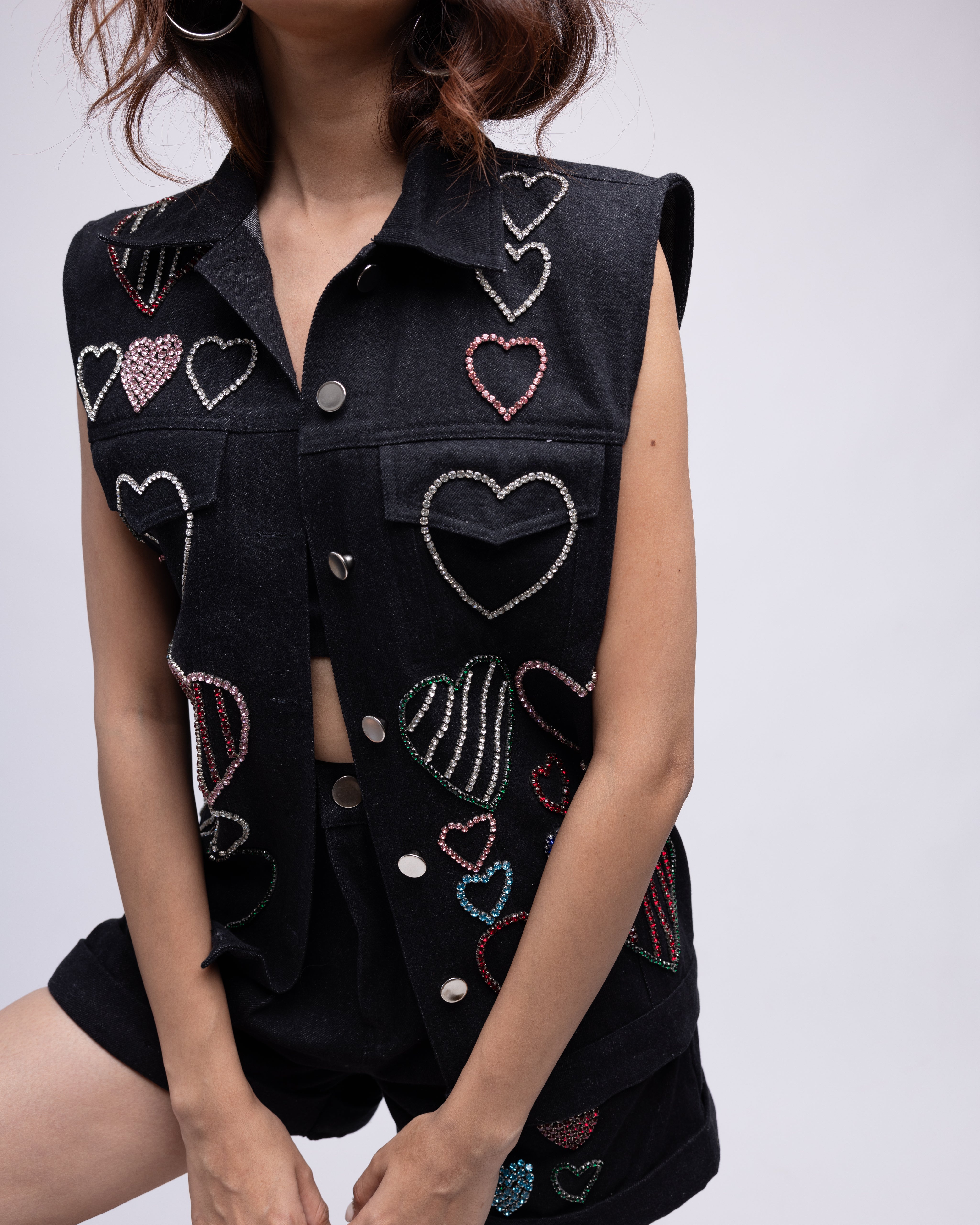 Sleeveless denim jacket with multi-colour embellished hearts