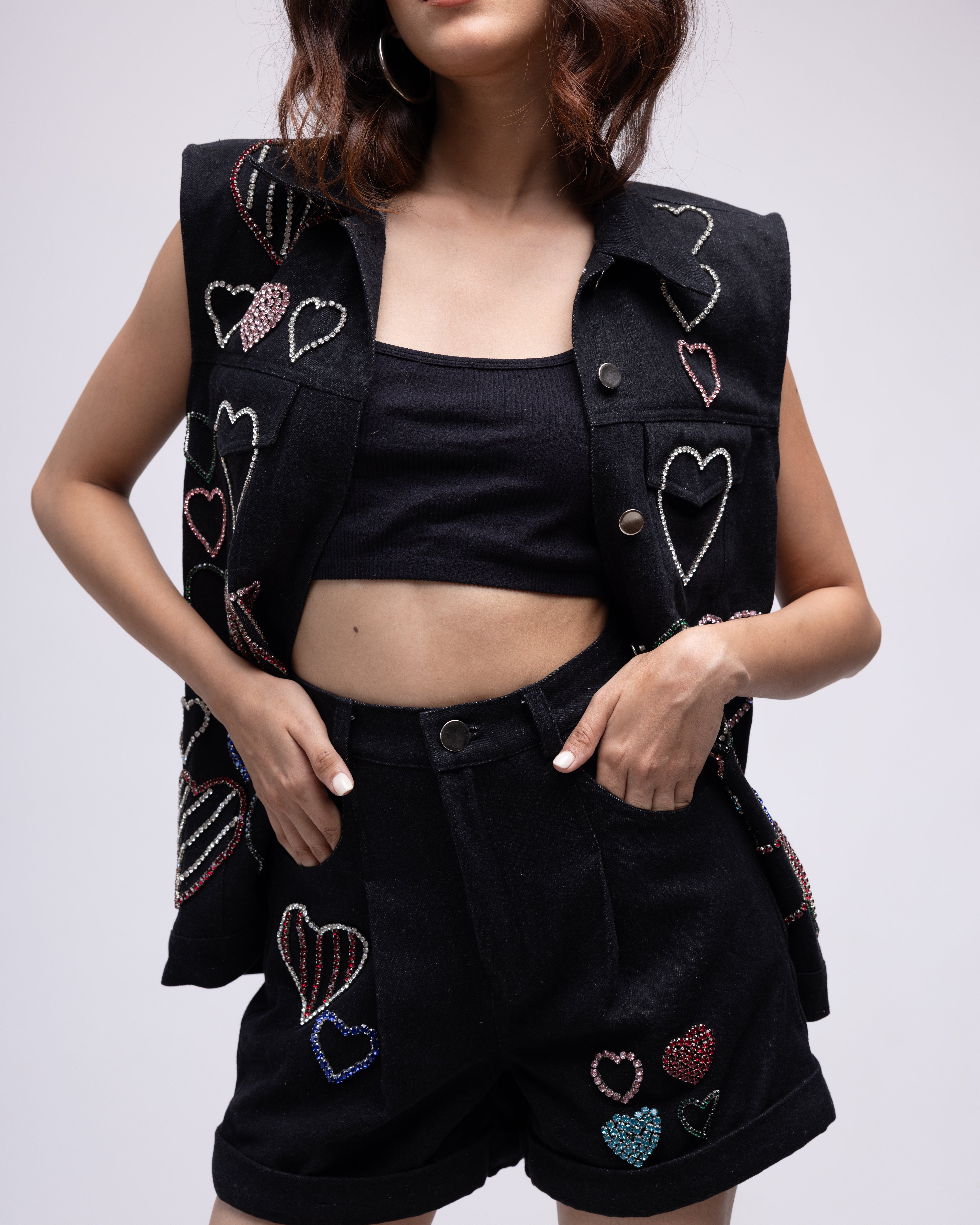 Sleeveless denim jacket with multi-colour embellished hearts