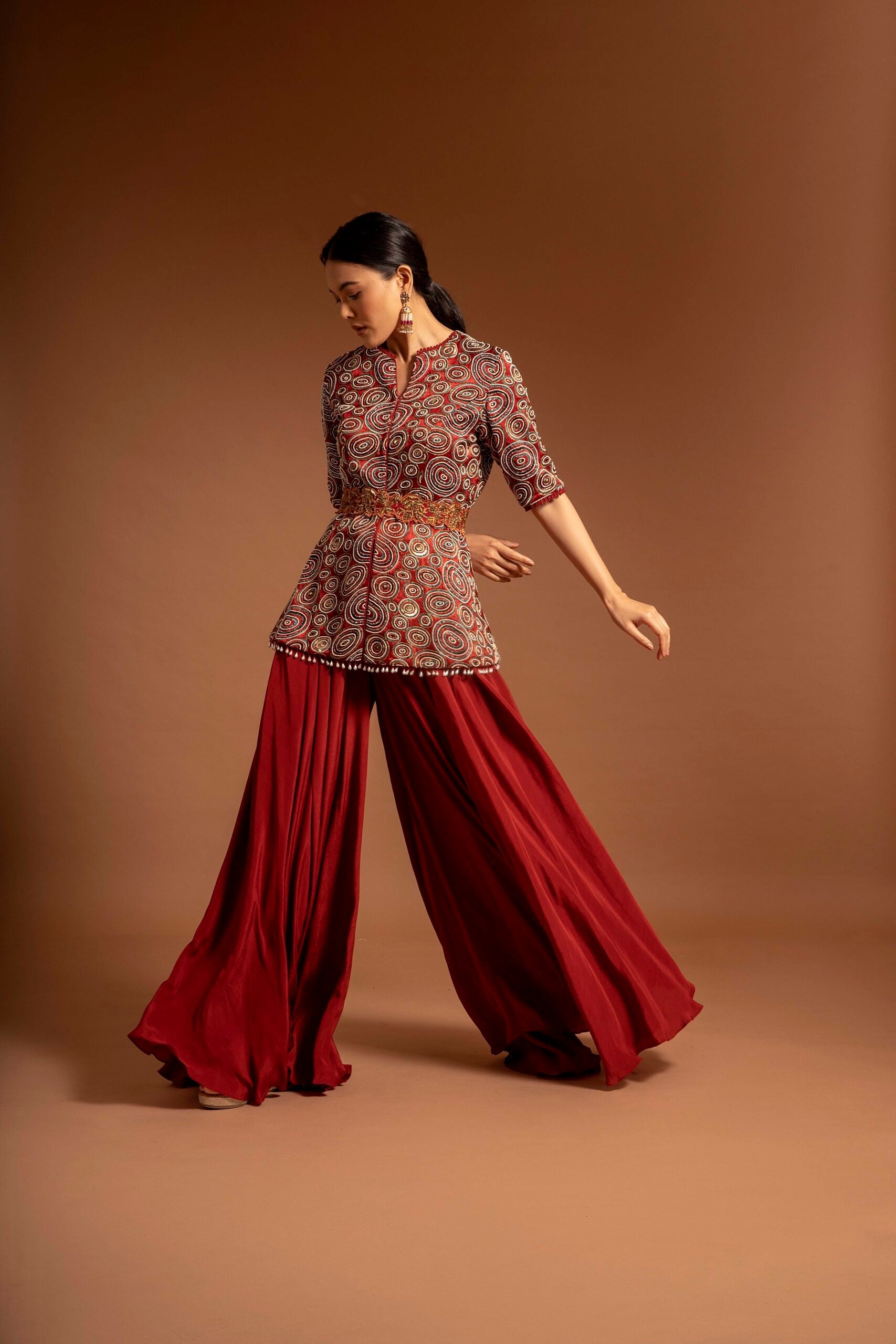 Red embroidered ajarkh peplum top with flare pants and embroidered waistbelt