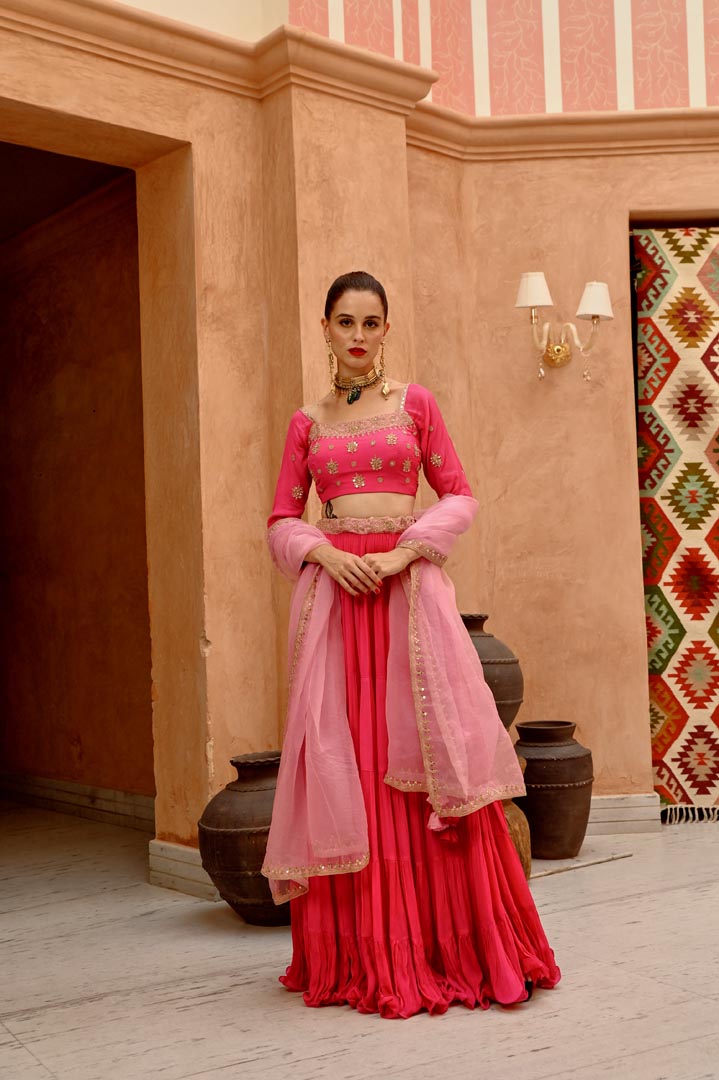 Image of Hot pink tier lehenga with blouse and  dupatta.