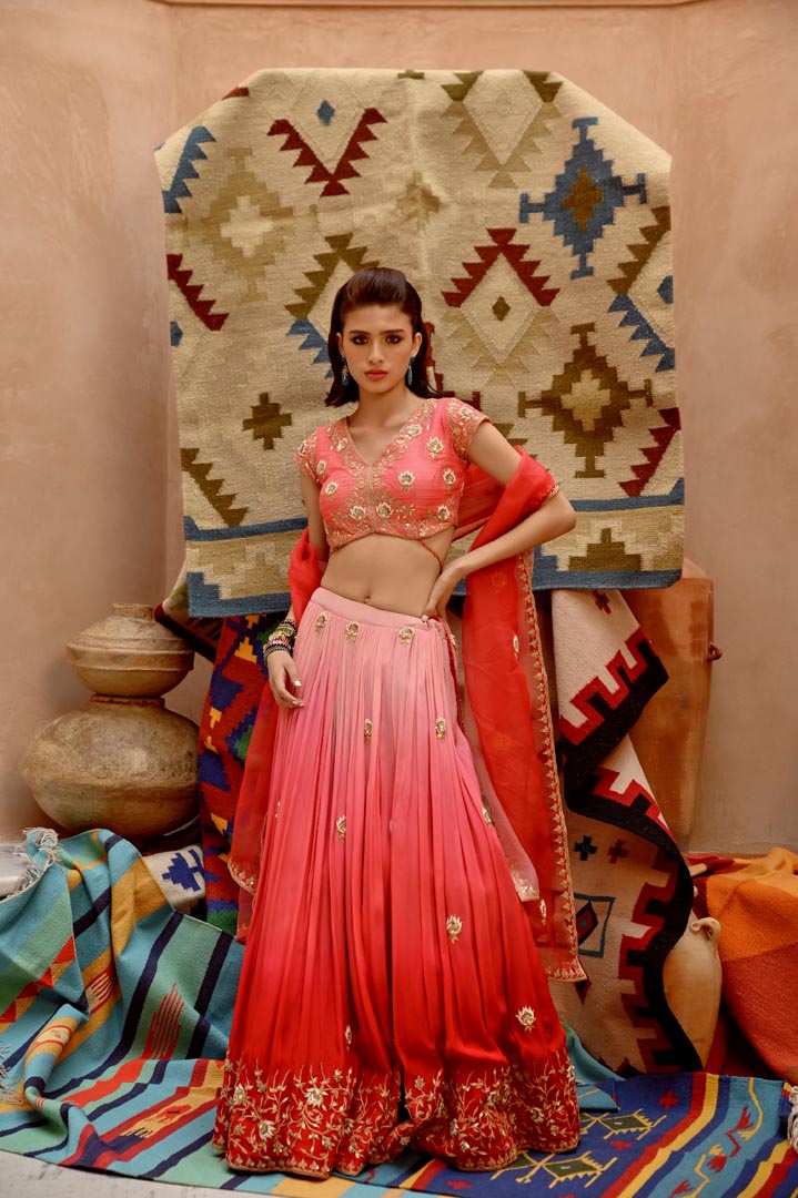 Image of Red and coral ombre ruched lehenga with blouse and dupatta