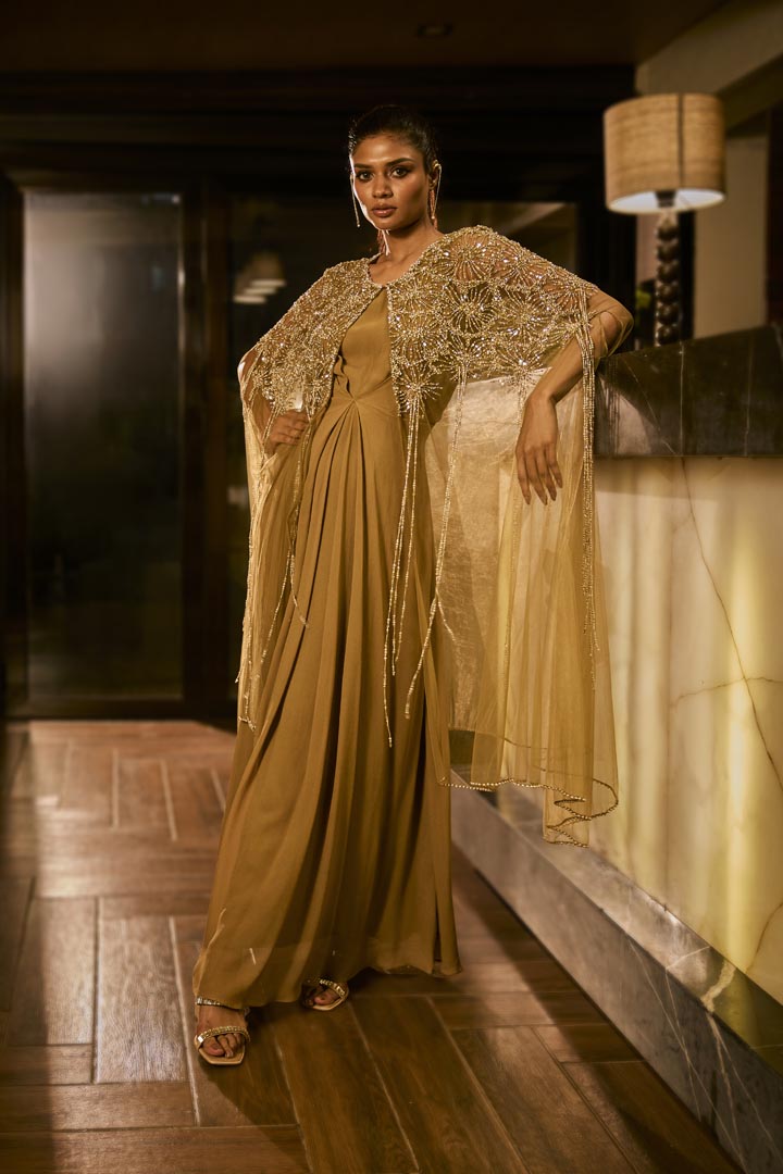 Olive green dress paired with an embellished sheer cape