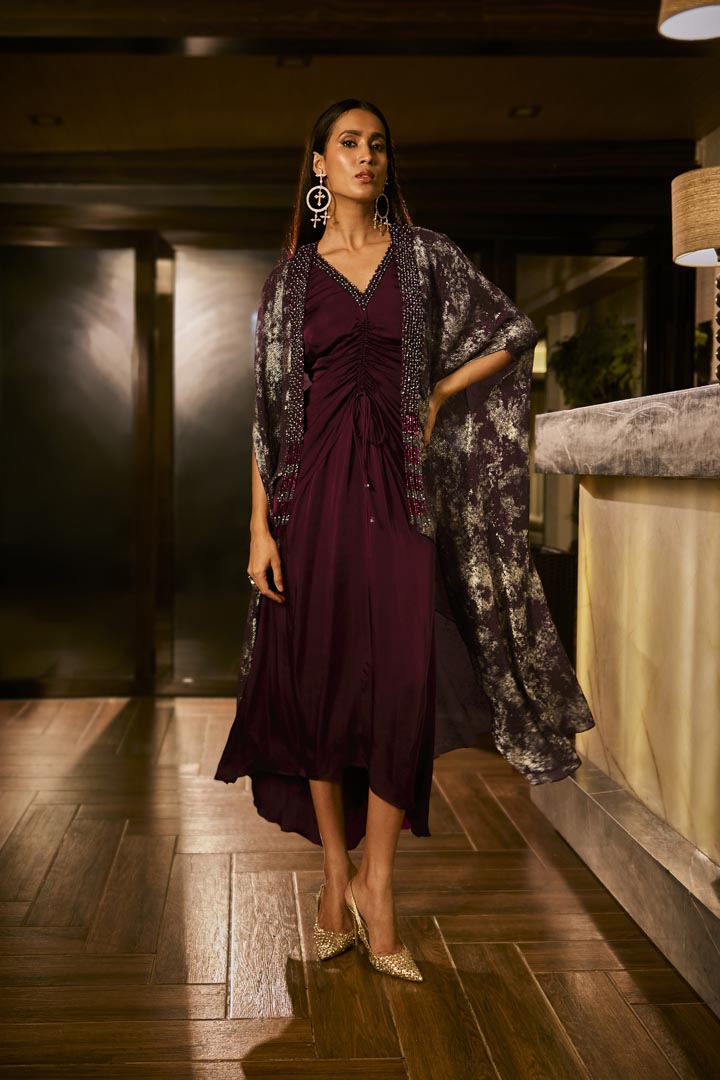 Ruched knot dress with a gold crushed foil cape