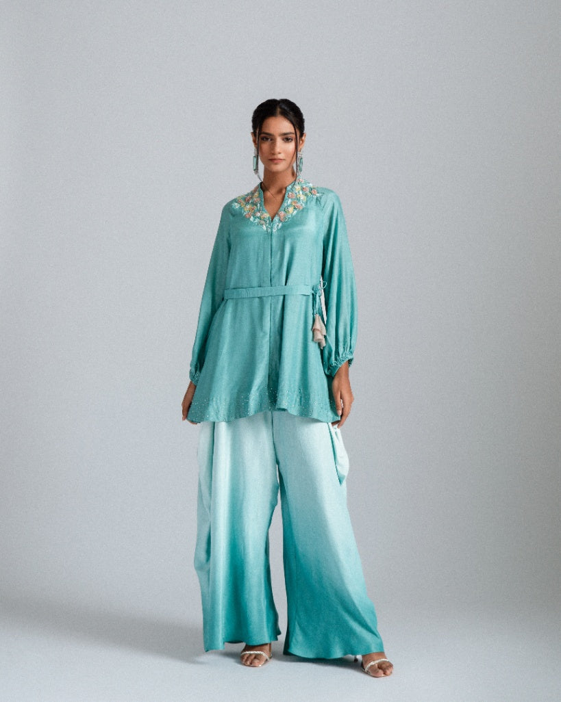 Aqua ombre silk mul mul tunic jacket with a belt and paired fusion dhoti drape trousers. 