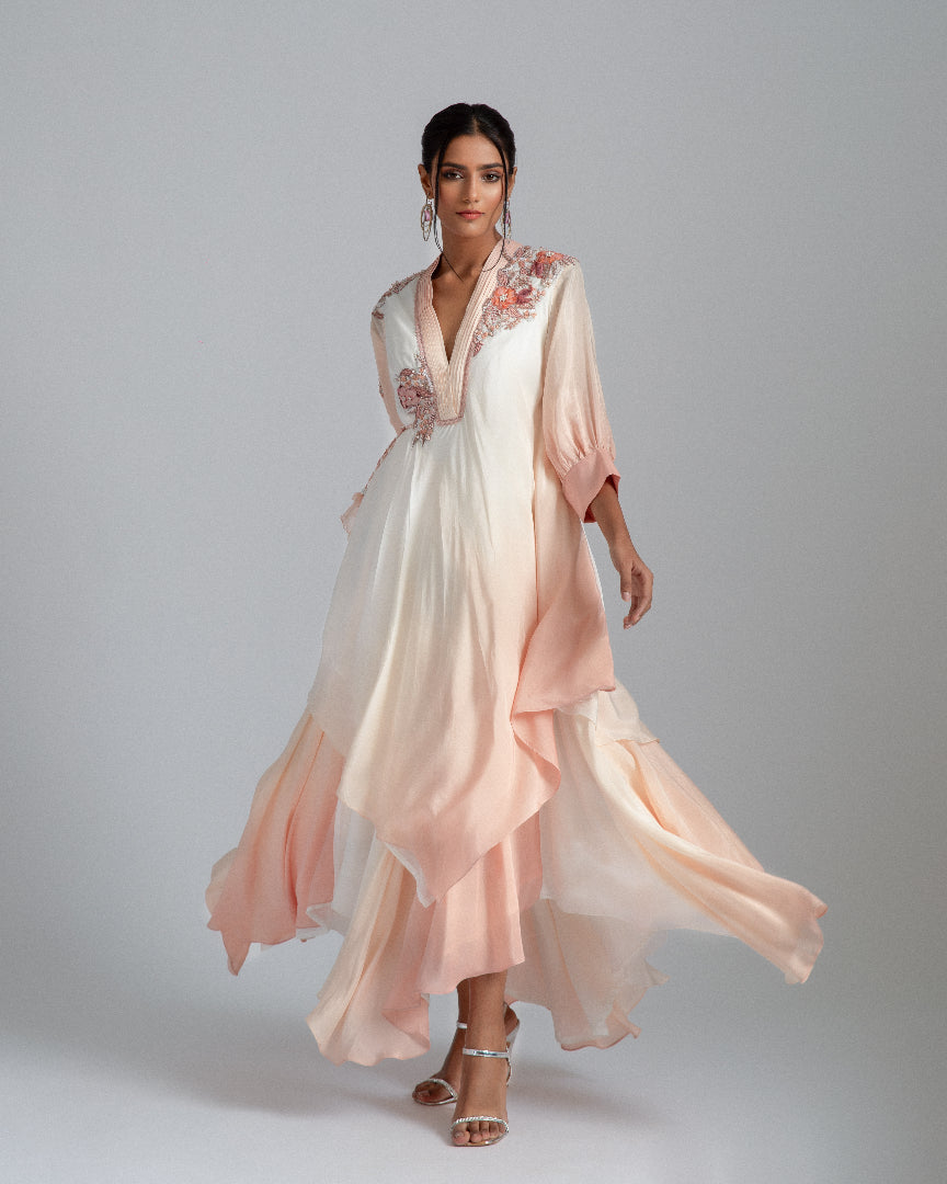 An off-white to Champagne ombré handkerchief-cut asymmetrical drape with a one-side tie and floral motifs. 