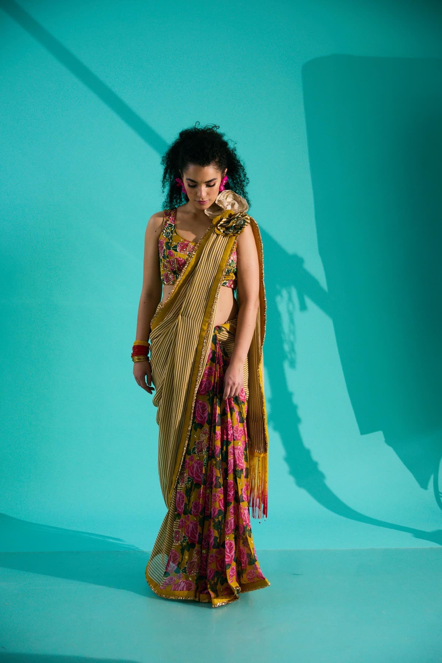 GEORGETTE STRIPED AND ROSE PRINTED SAREE WITH FRINGES DETAIL PAIRED WITH EMB. FLORAL BLOUSE