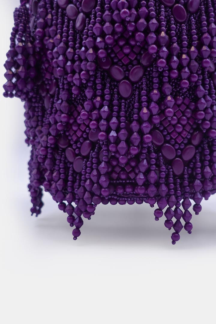 Handcrafted purple potli bag adorned with intricate bead embellishments