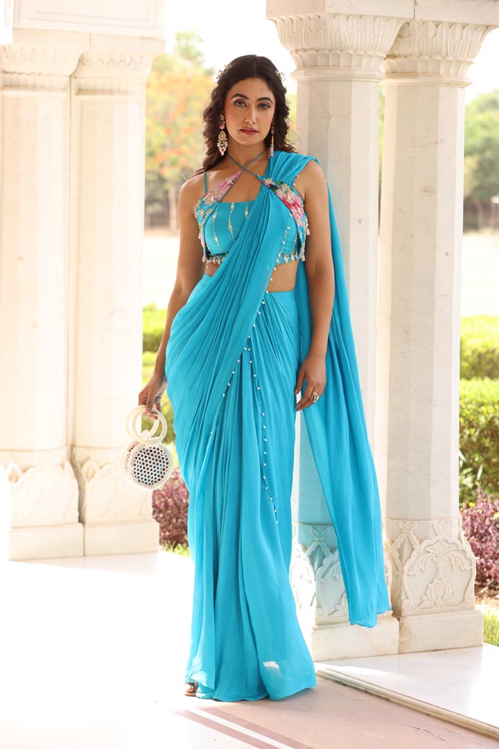 Image of Featuring Drape saree with pearl details on Georgette base. Paired with halter neck tie detail on printed chinnon chiffon fabric