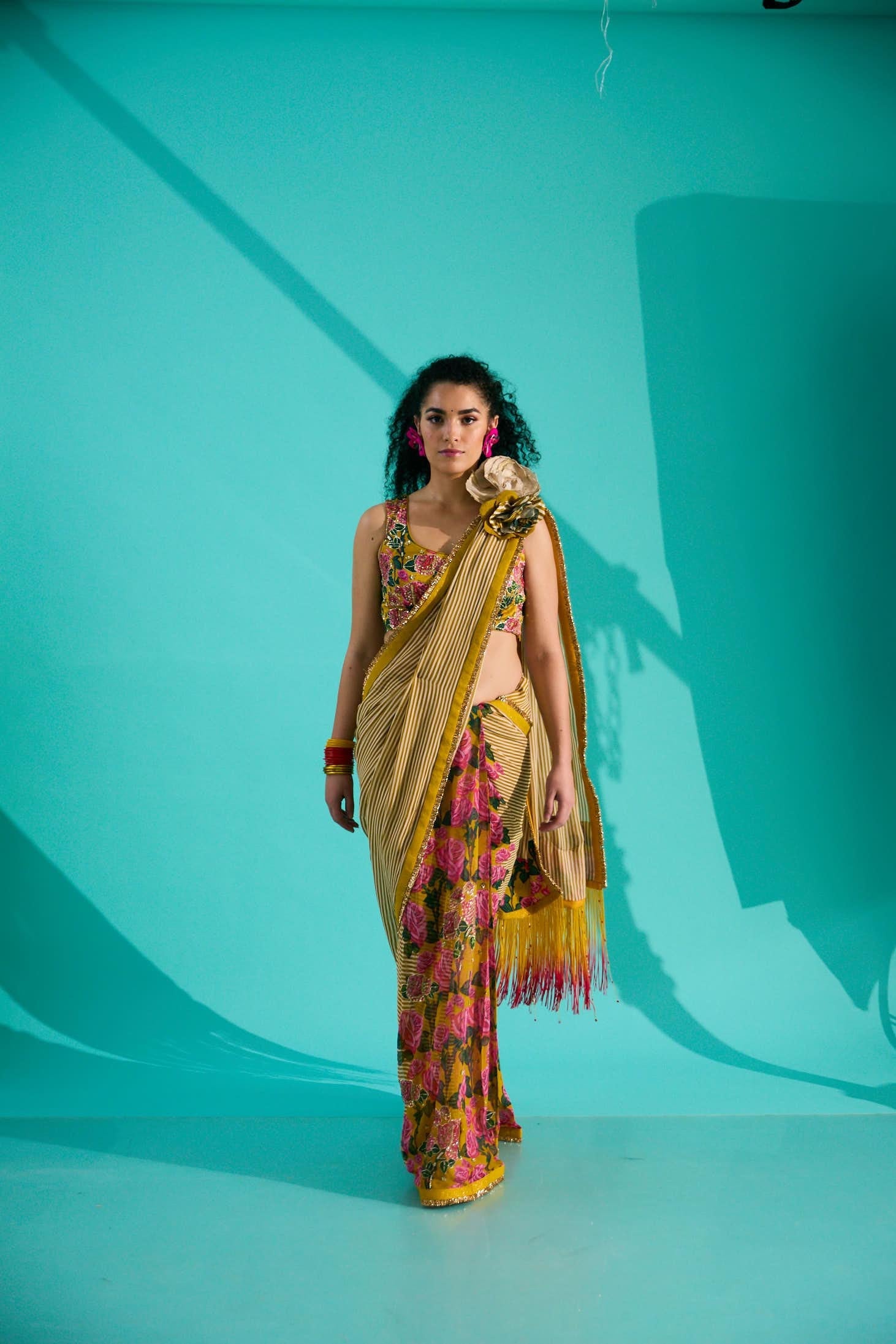 GEORGETTE STRIPED AND ROSE PRINTED SAREE WITH FRINGES DETAIL PAIRED WITH EMB. FLORAL BLOUSE