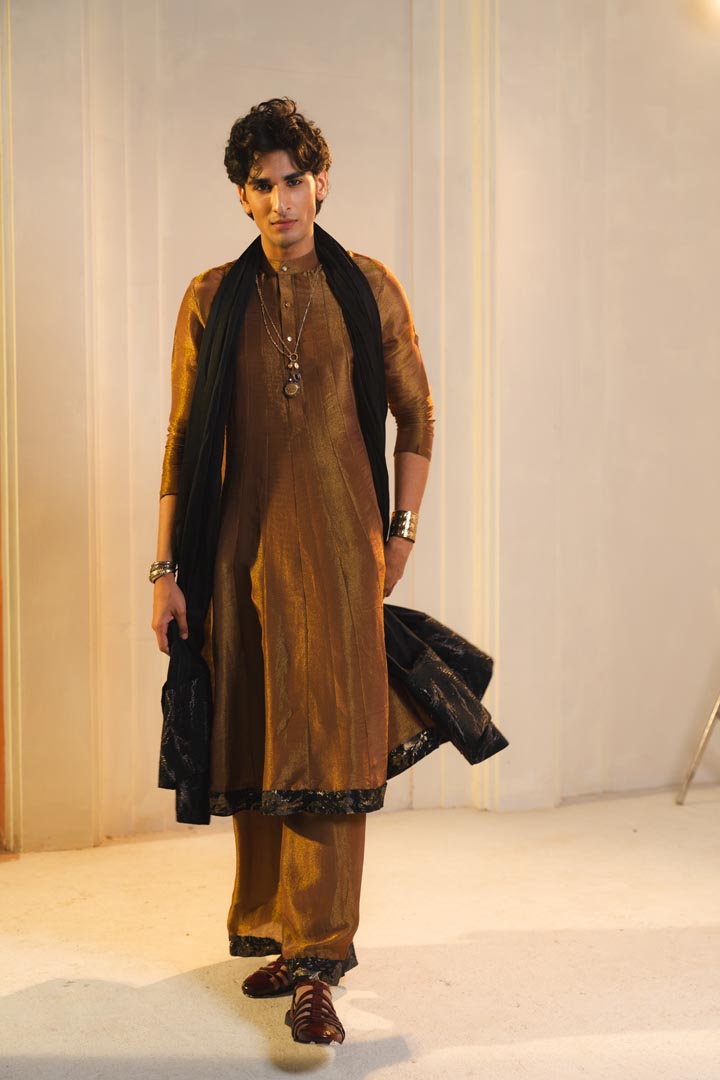 Anarkali kurta in gold, paired with flared trousers and a contrasting black dupatta.
