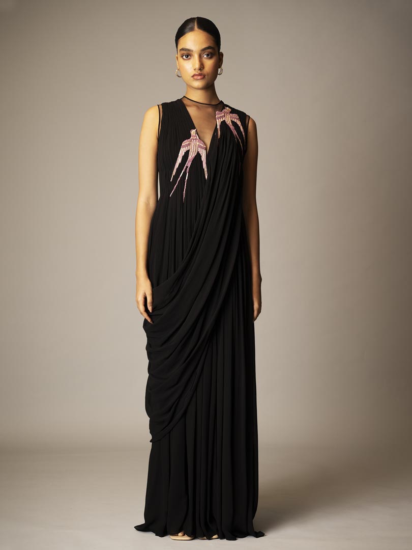 Black drape saree gown with pink 
embellished detailing and sheer neckline.