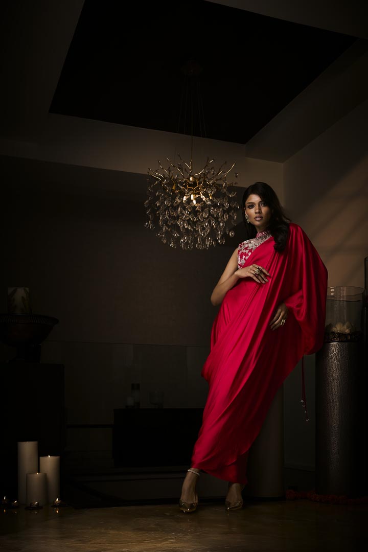 A sangria silk satin pre-draped saree paired with an intricately embroidered blouse.