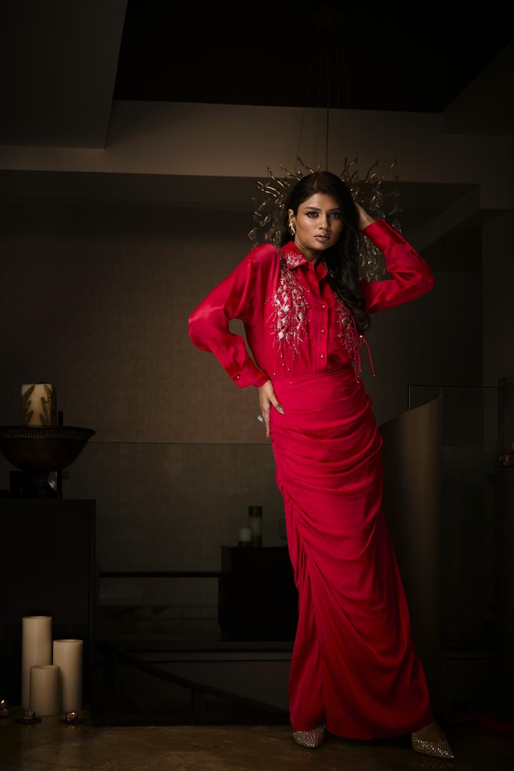 A sangria silk satin cowl skirt paired with an organza shirt, delicately hand-embroidered with sequins and beads.