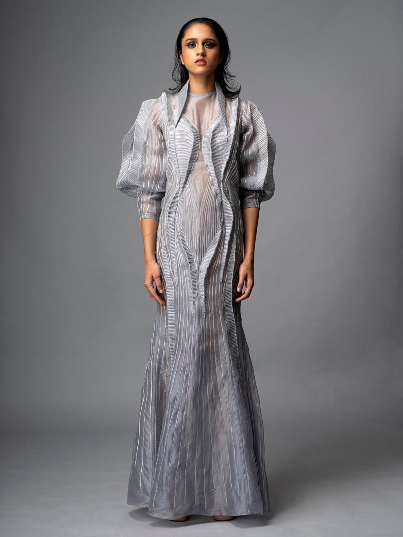 Silver embellished gown with
 sheer detailing and dramatic puff sleeve