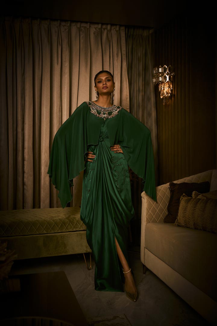 An emerald green pure silk satin dress with an attached cape and intricate beaded neckline.