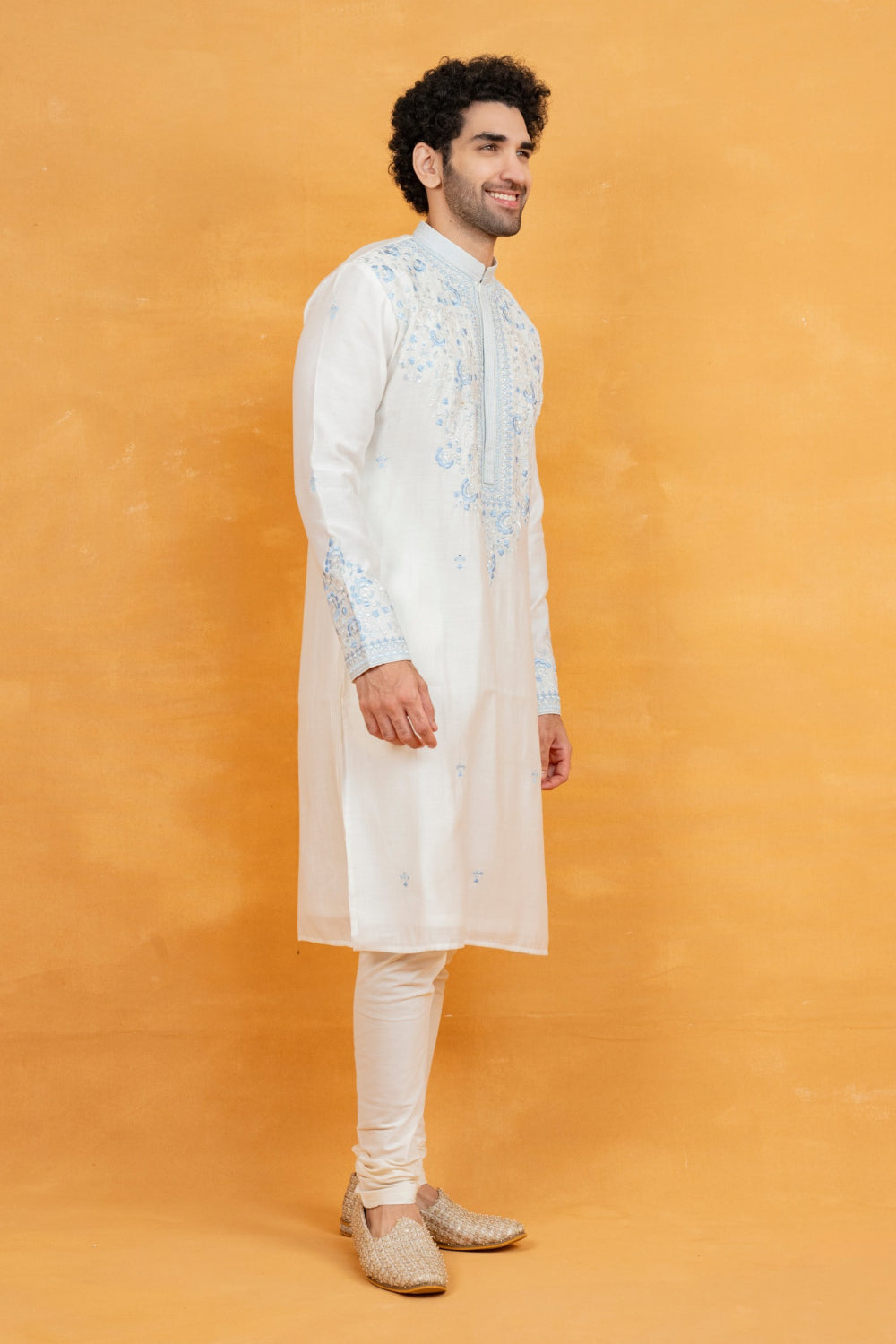 Cream silk kurta set with blue resham embroidery and mirror work