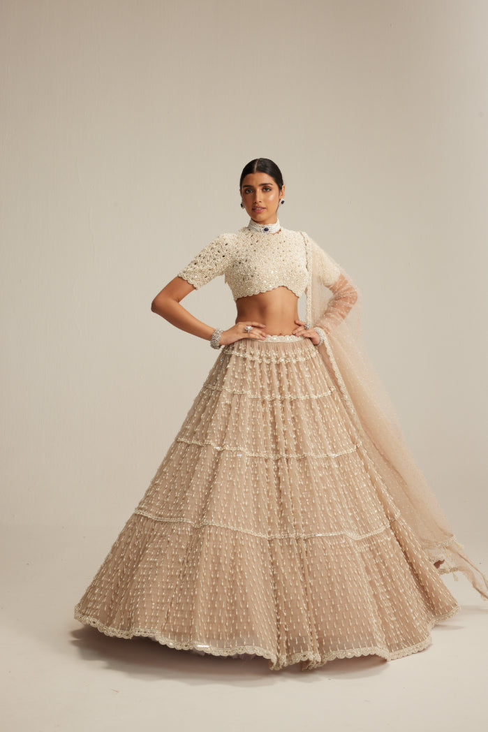Light Beige Pearl Drop Multi Tier Lehenga With High Neck Blouse Set.