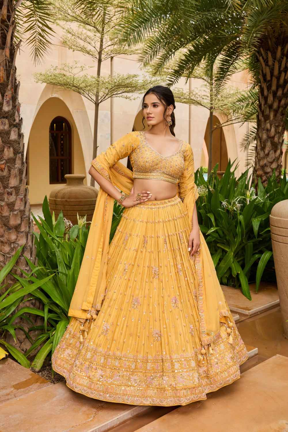 Yellow silk lehenga choli with sequins and hand cut dana work