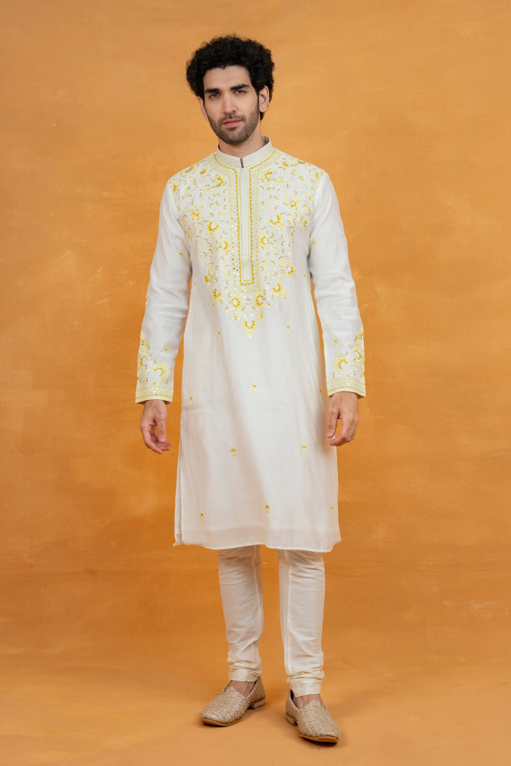 Cream silk kurta set with yellow resham embroidery and mirror work