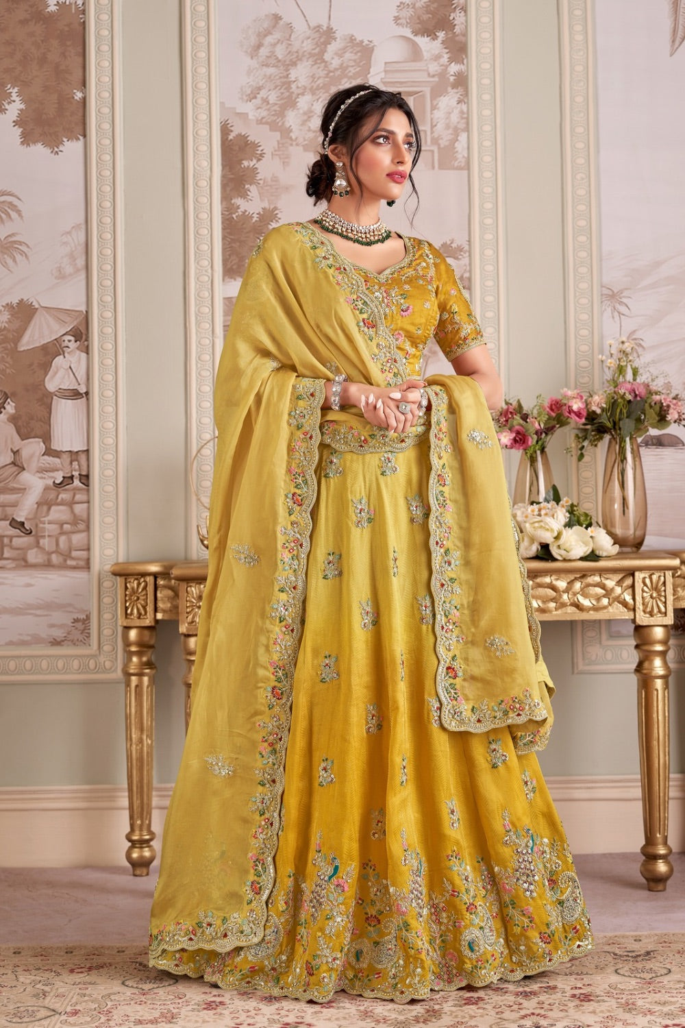 Yellow soft silk lehenga choli with machine and hand work