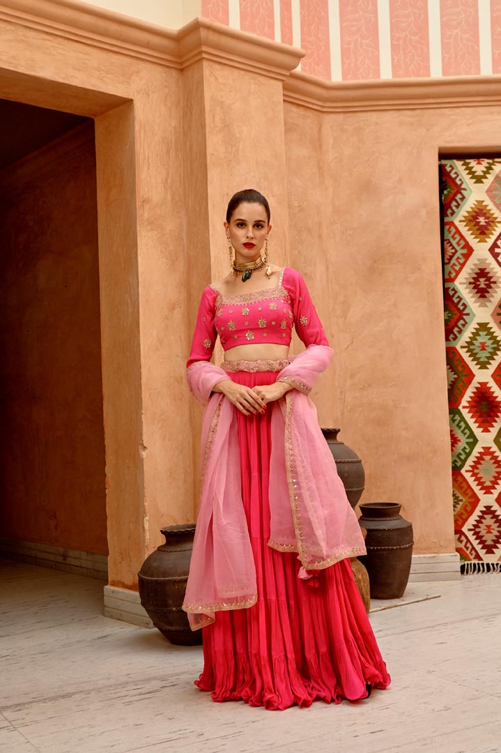 Image of Hot pink tier lehenga with blouse and  dupatta.