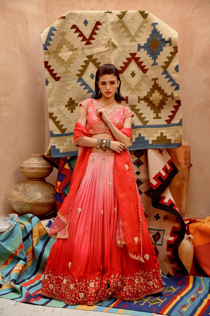 Image of Red and coral ombre ruched lehenga with blouse and dupatta