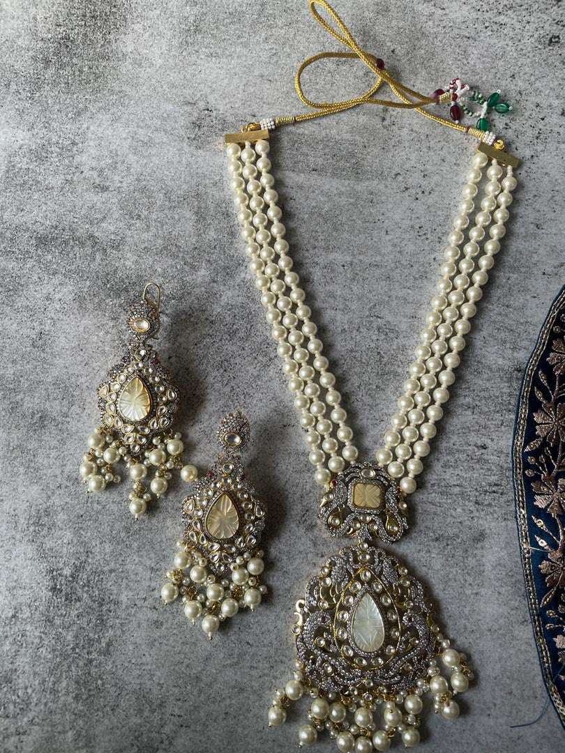 Long Pearl Necklace Paired with Matching Carved Pearl Earrings