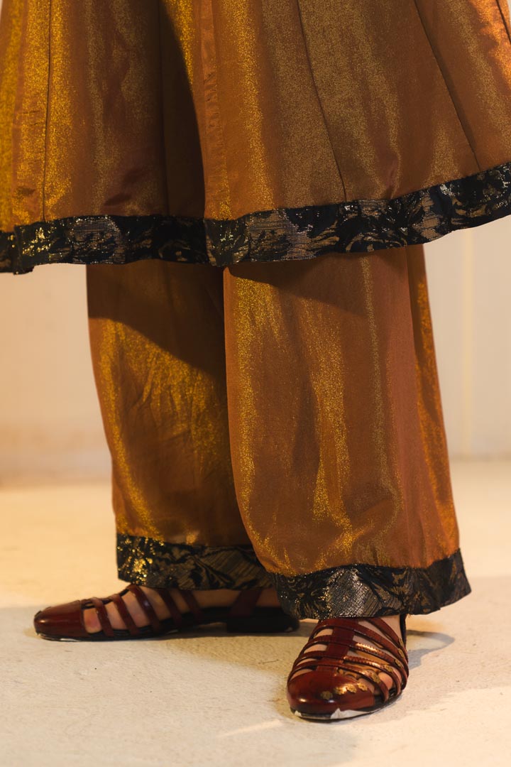Anarkali kurta in gold, paired with flared trousers.