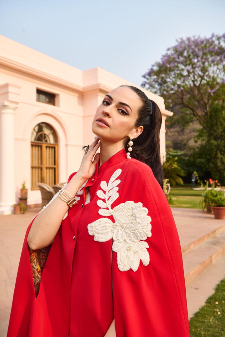 red and white embroidered cape