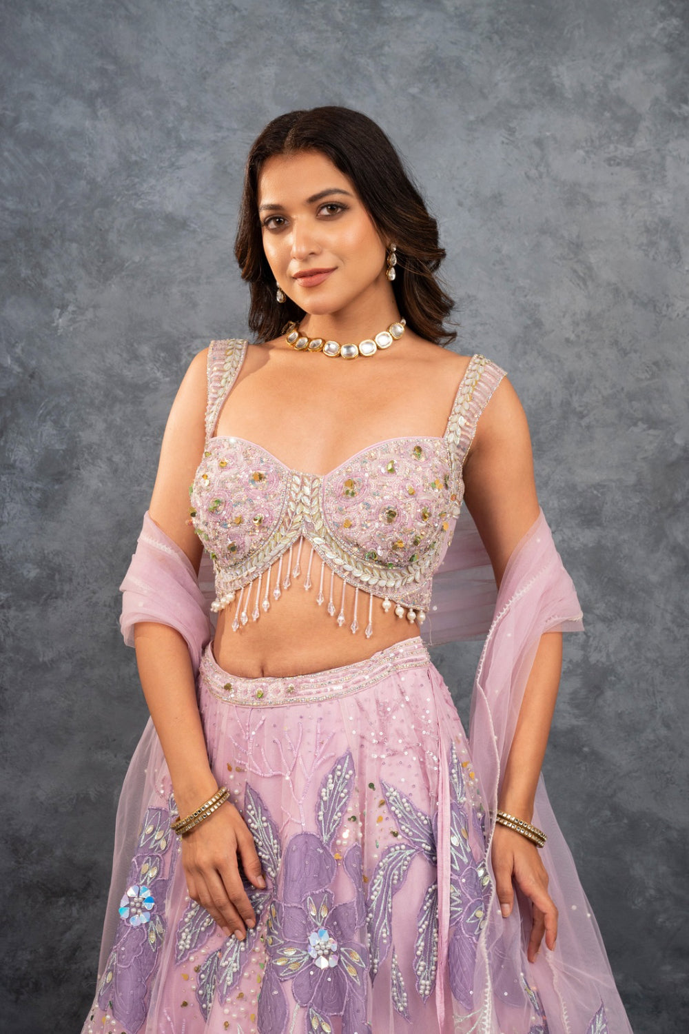 Baby pink net lehenga choli with sequins, hand-cut dana, and pearl accents