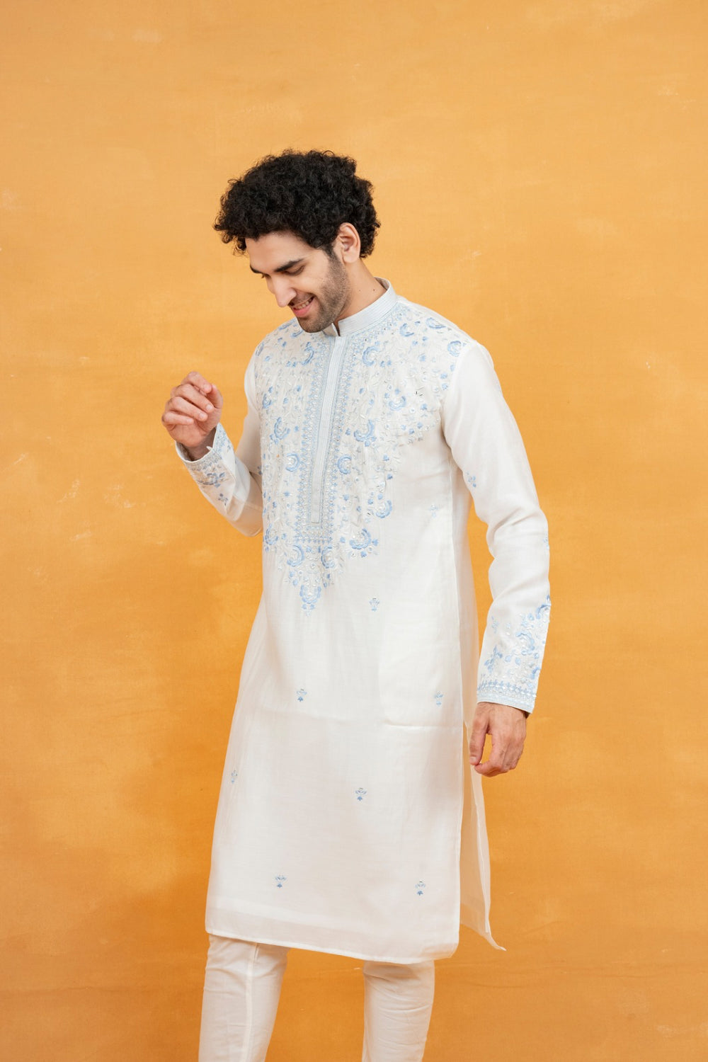 Cream silk kurta set with blue resham embroidery and mirror work