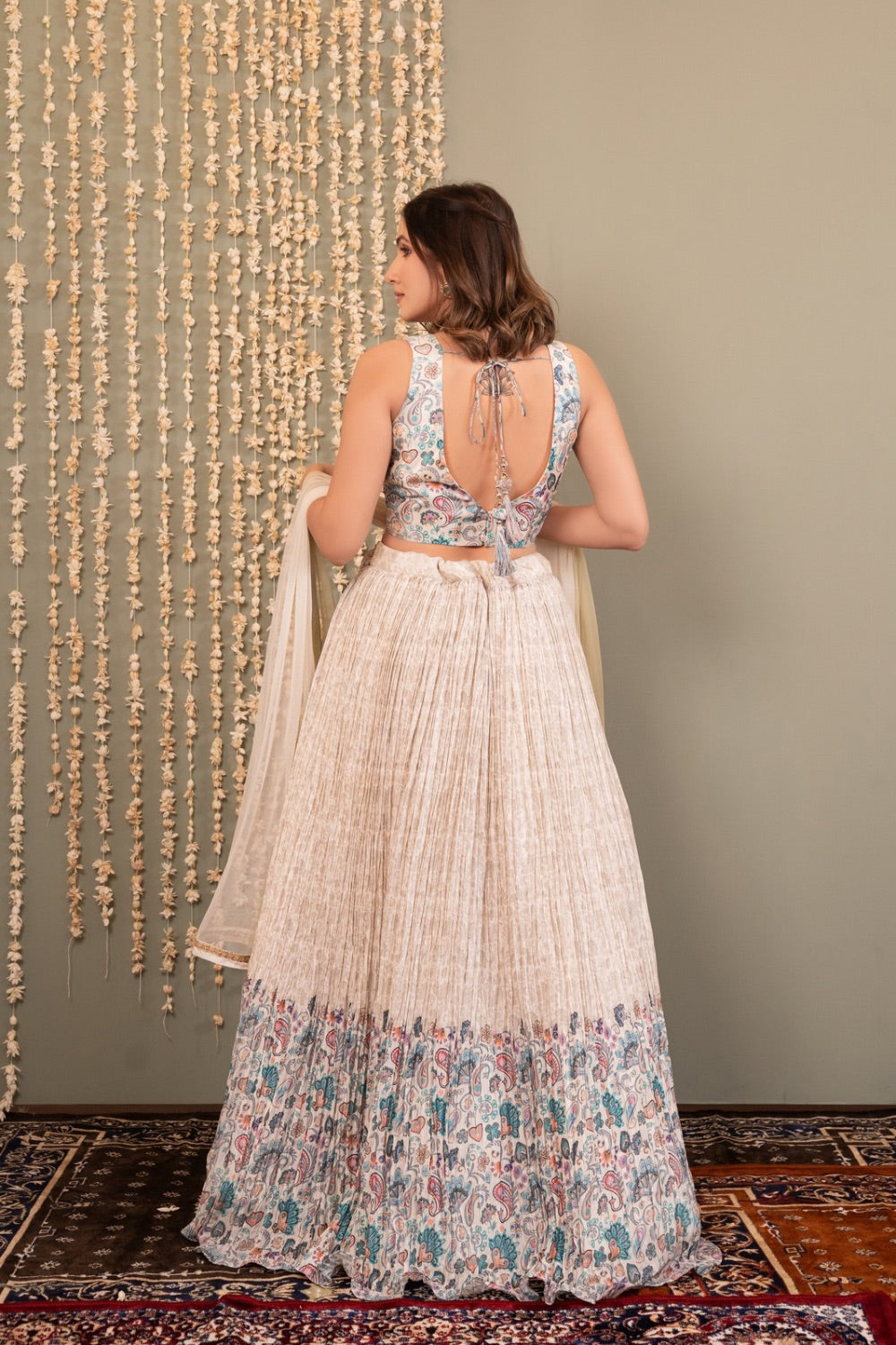 Cream white crepe silk lehenga choli with printed and mirror work