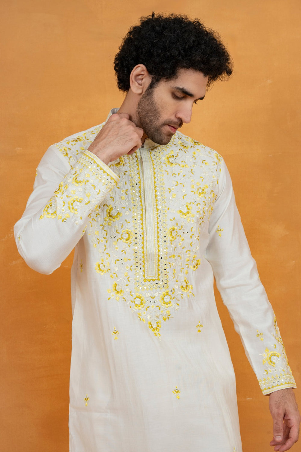 Cream silk kurta set with yellow resham embroidery and mirror work