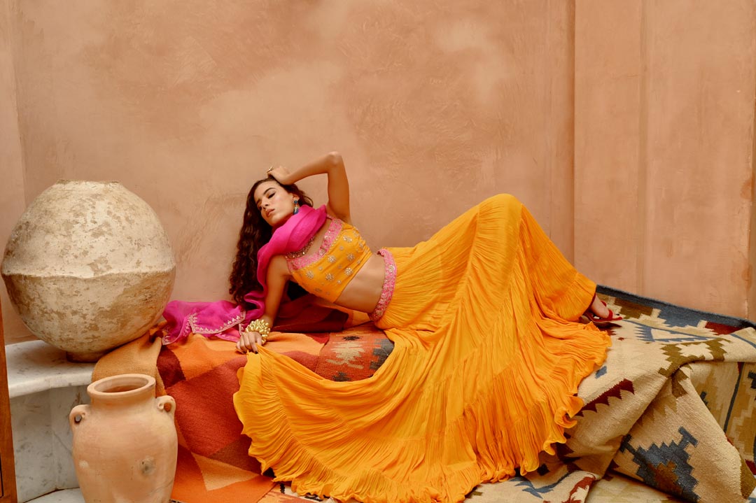 Image of Turmeric yellow tier lehenga with blouse and dupatta.