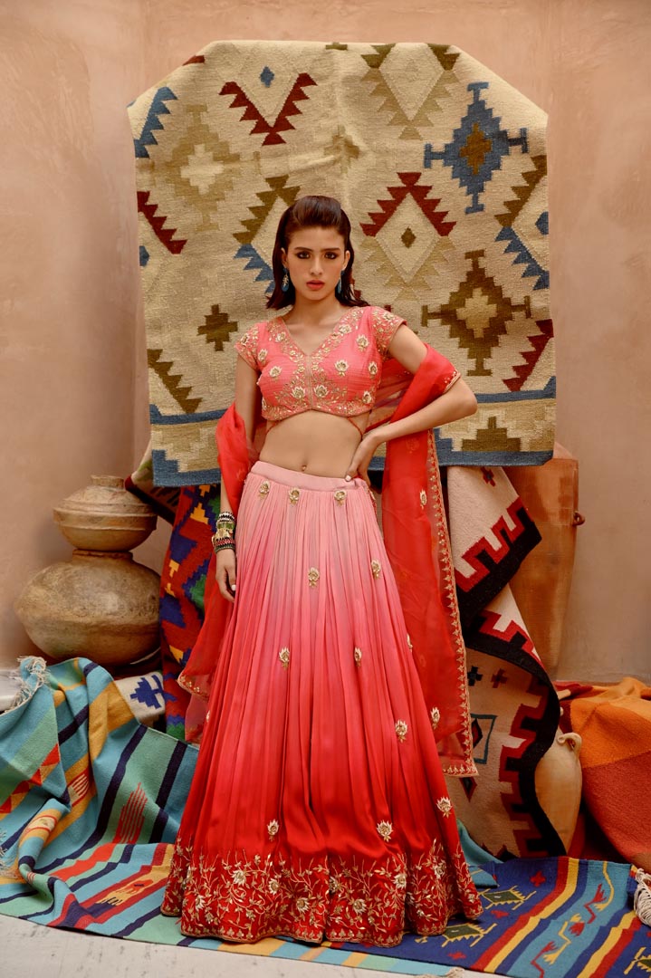 Image of Red and coral ombre ruched lehenga with blouse and dupatta