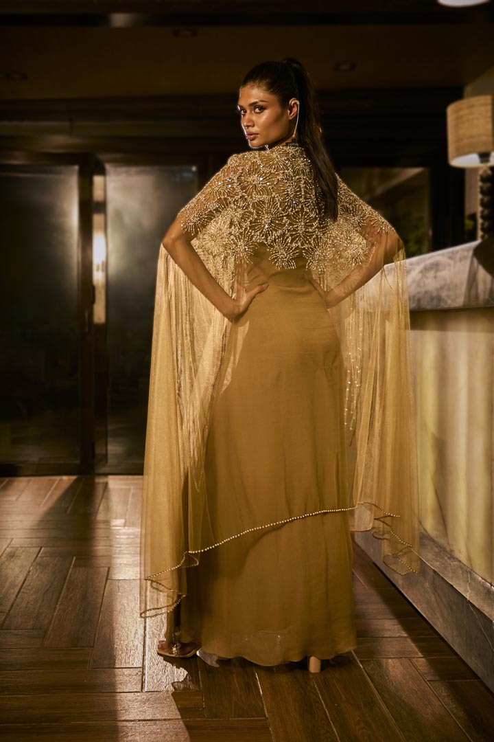 Olive green dress paired with an embellished sheer cape