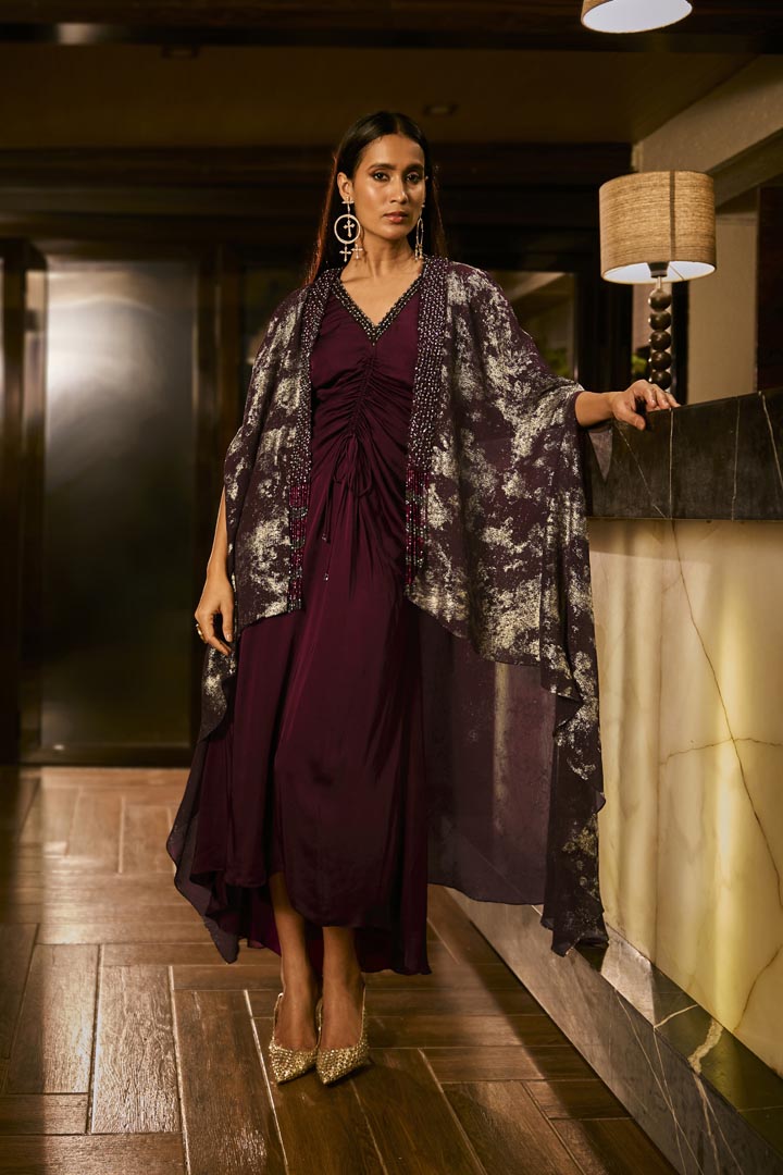 Ruched knot dress with a gold crushed foil cape