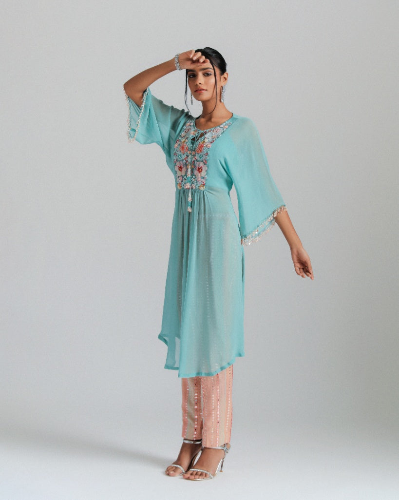 Georgette kaftan paired with mirror work trousers.