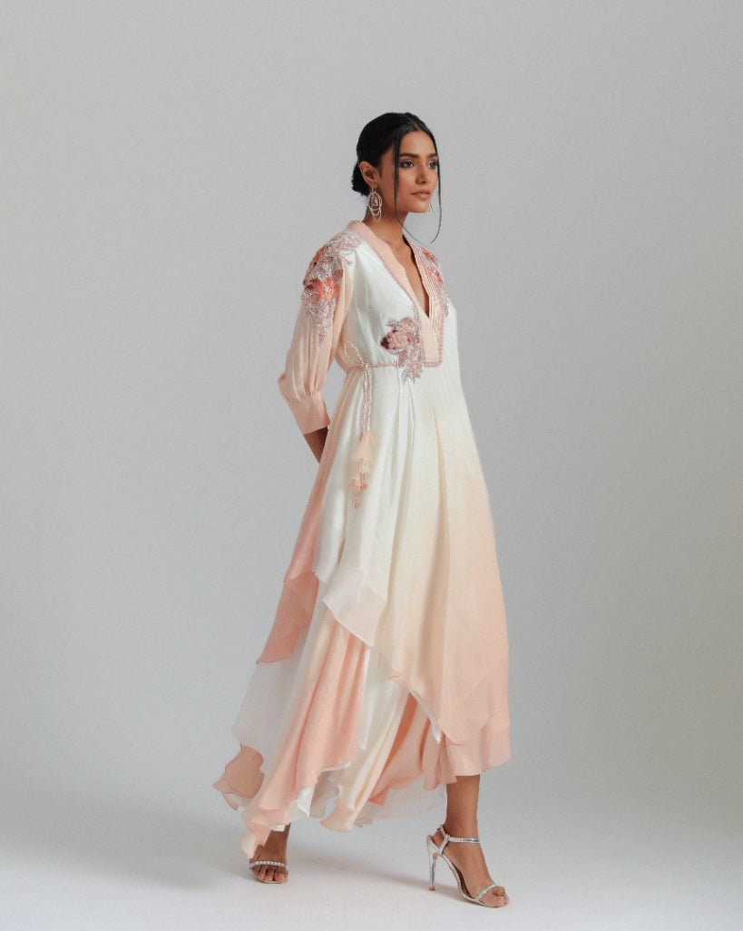 An off-white to Champagne ombré handkerchief-cut asymmetrical drape with a one-side tie and floral motifs. 