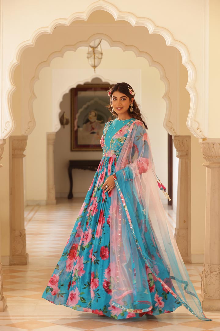 Image of Featuring Floral printed Anarkali with hand embroidered yoke and churidaar sleeves. Paird with double shadede net embroidered dupatta