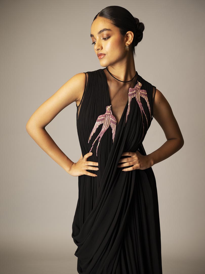 Black drape saree gown with pink 
embellished detailing and sheer neckline.Â”