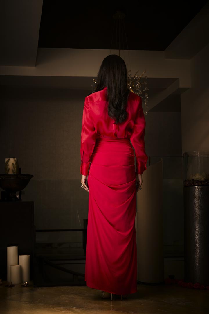 A sangria silk satin cowl skirt paired with an organza shirt, delicately hand-embroidered with sequins and beads.