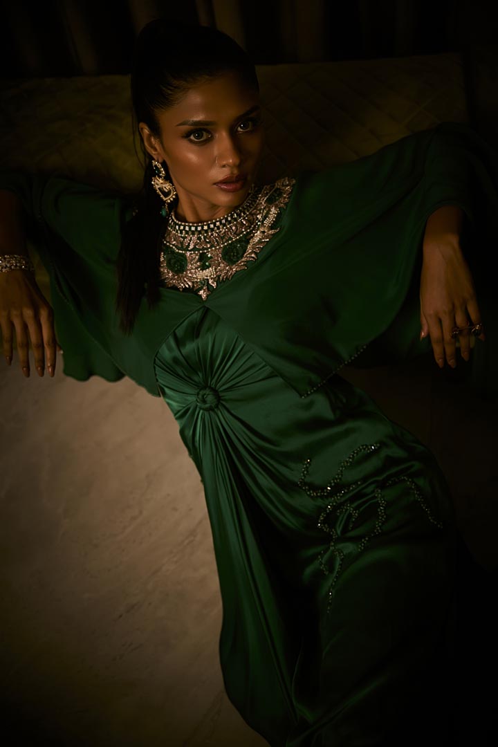 An emerald green pure silk satin dress with an attached cape and intricate beaded neckline.
