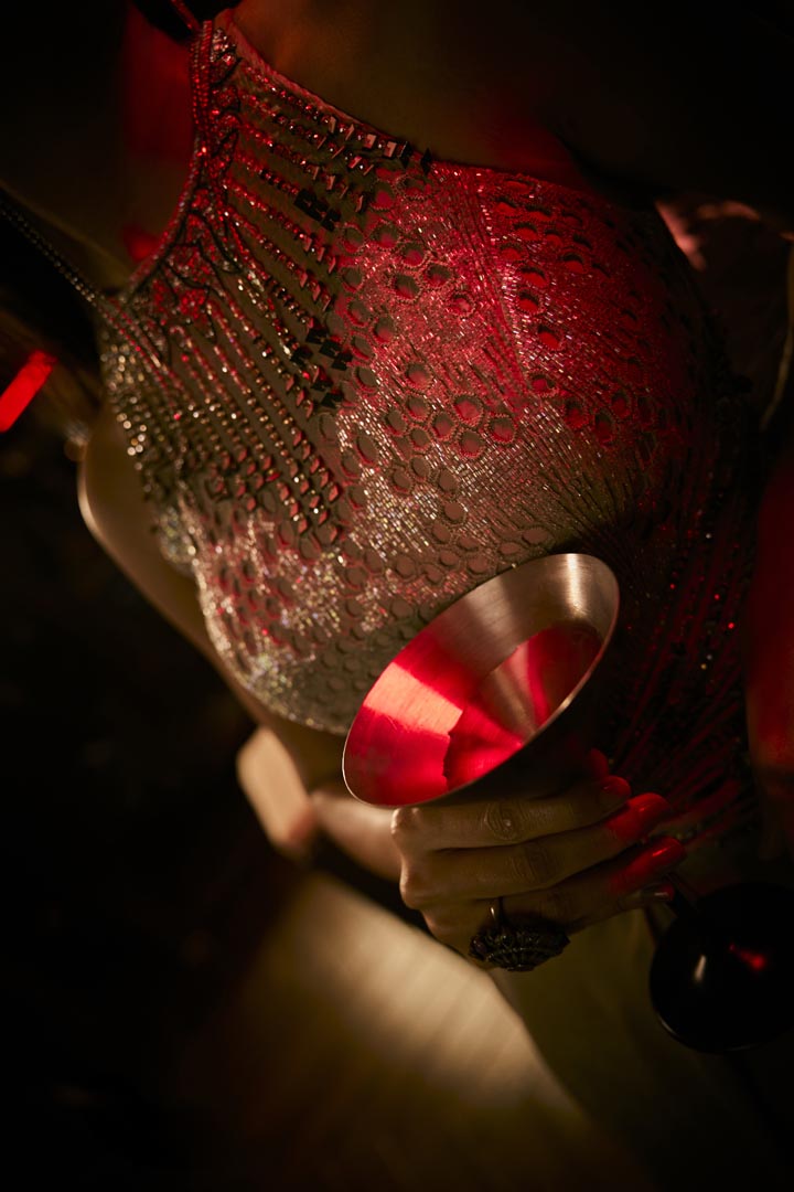 A taupe crushed fabric jumpsuit gown with intricate bead embroidery for a refined, modern silhouette.