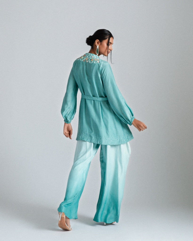 Aqua ombre silk mul mul tunic jacket with a belt and paired fusion dhoti drape trousers. 