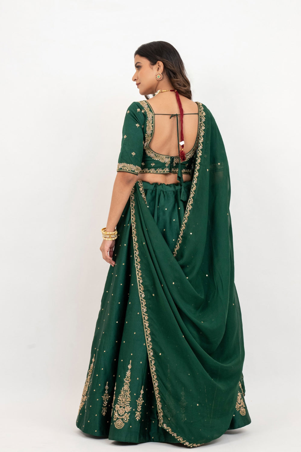 Bottle green soft silk zardozi embroidered lehenga choli with hand cut dana work