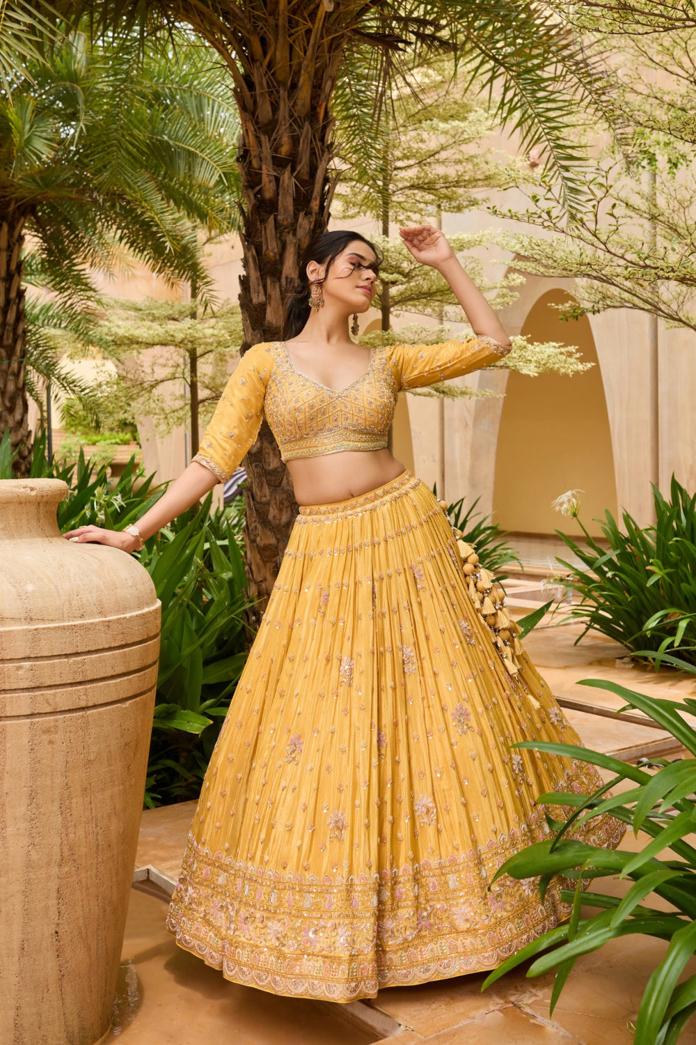 Yellow silk lehenga choli with sequins and hand cut dana work