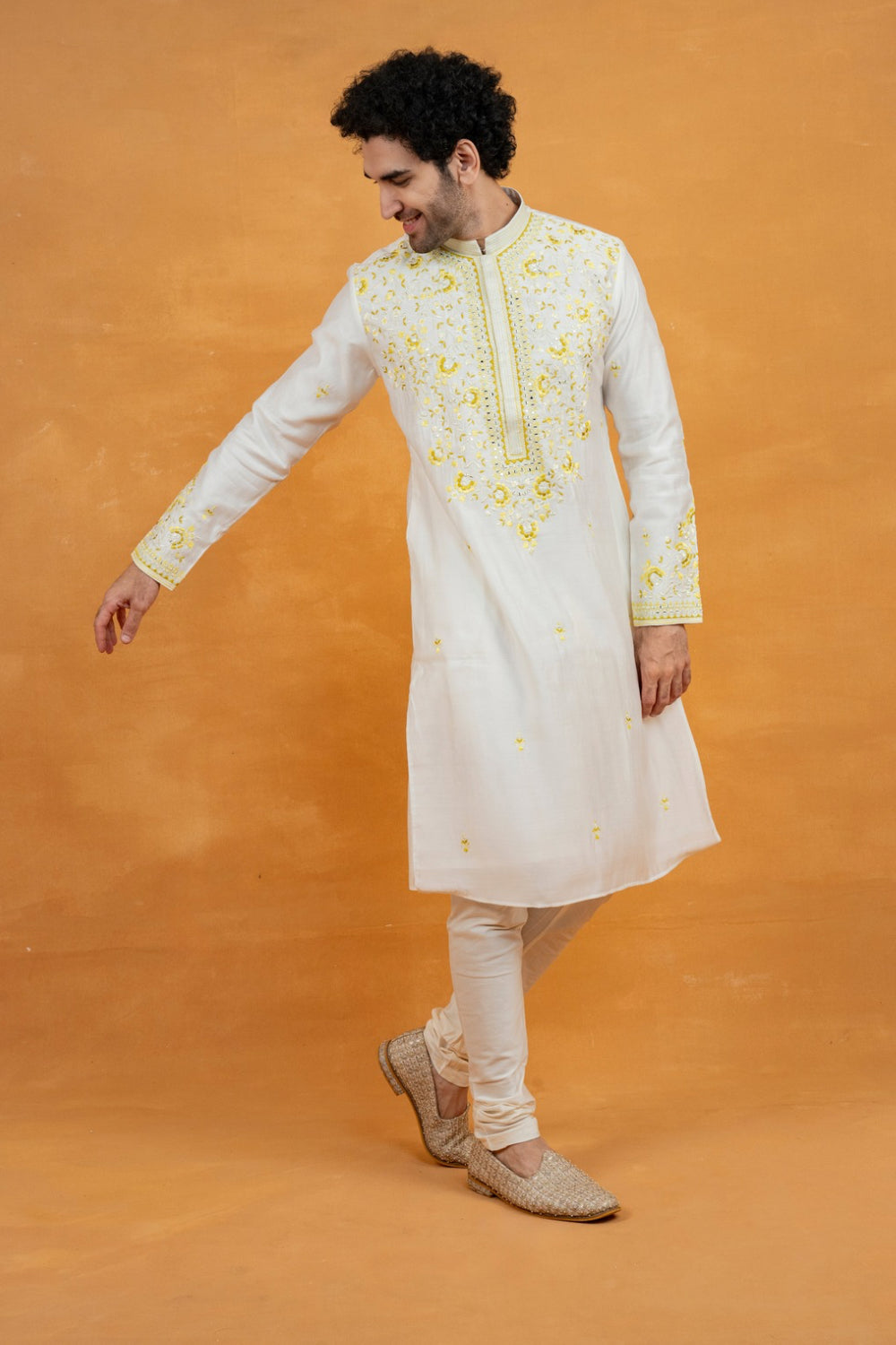 Cream silk kurta set with yellow resham embroidery and mirror work