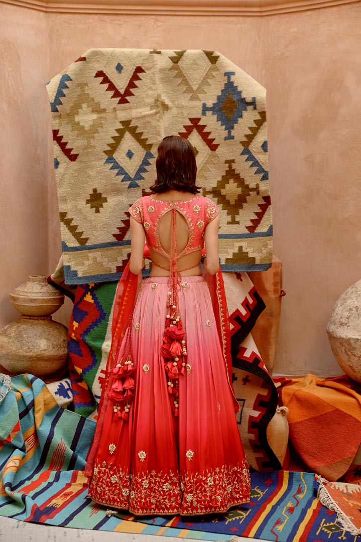 Image of Red and coral ombre ruched lehenga with blouse and dupatta