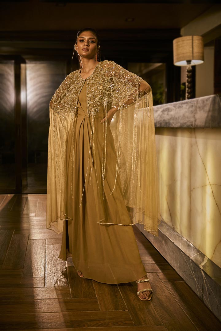 Olive green dress paired with an embellished sheer cape